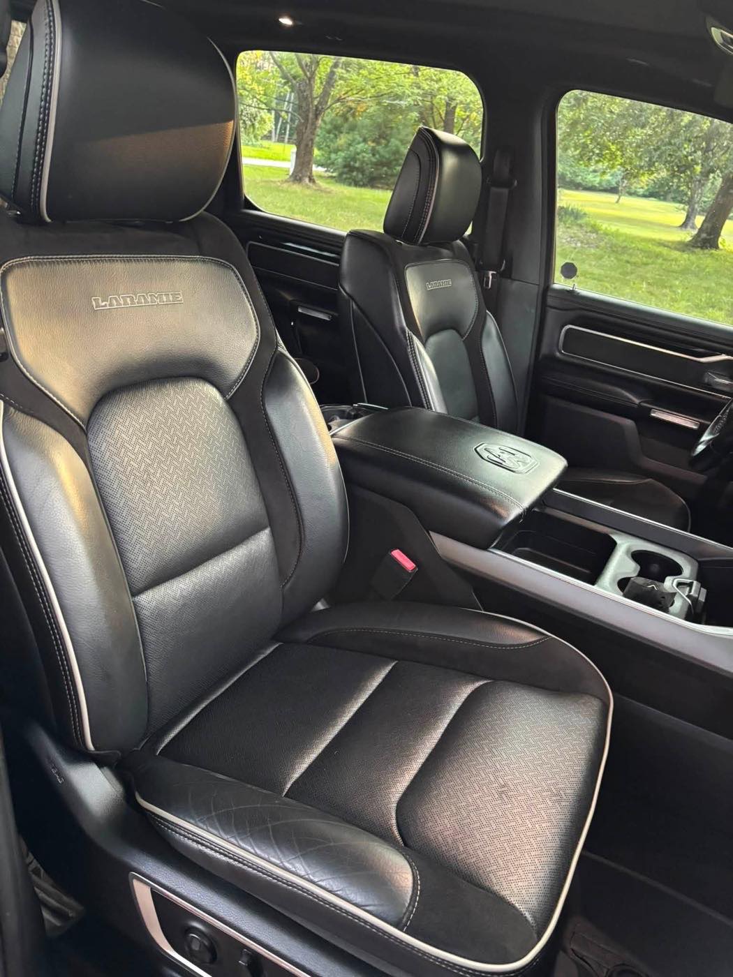 Front seats after detailing, clean black leather