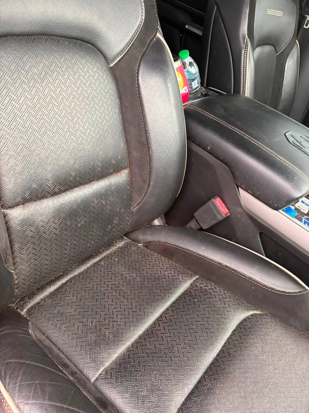 Front seat and console before detailing, dusty with debris